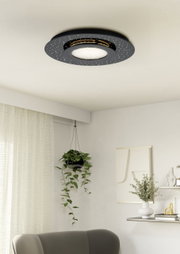 Moderne LED-Deckenleuchte in schwarzem Design mit funkelnden Details, von unten betrachtet in einem stilvoll eingerichteten Raum.