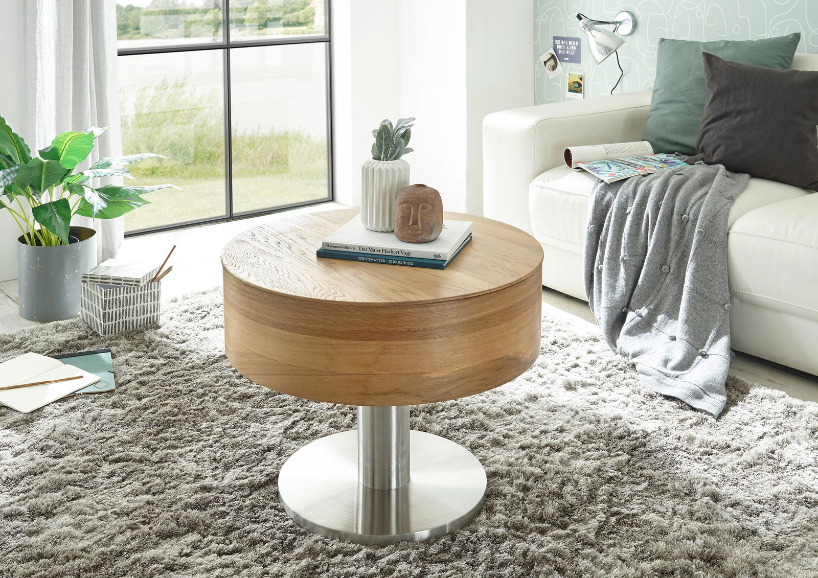 Zurbrüggen Couchtisch TANGER Moderner runder Couchtisch aus Holz mit Metallfuß, dekoriert mit Büchern und einer Vase, in einem gemütlichen Wohnzimmer mit Teppich und Sofa, seitliche Perspektive.
