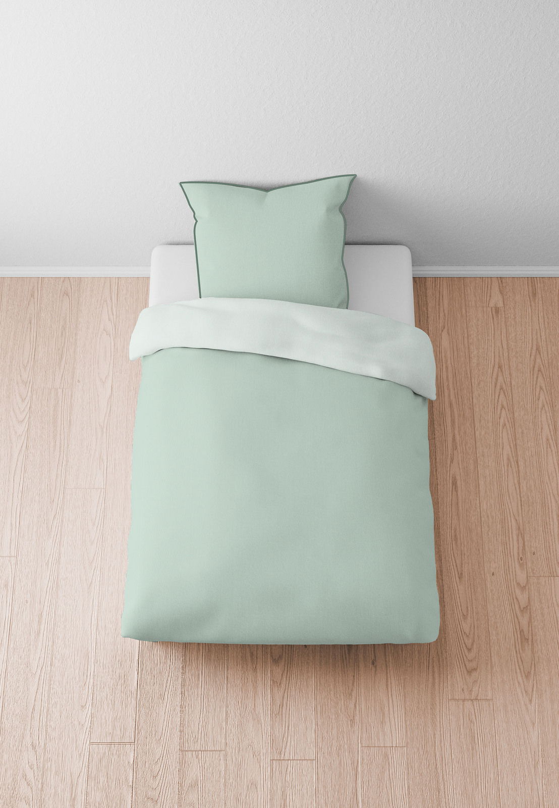 Bettwäsche-Set in Mintgrün, bestehend aus einem Kissenbezug und einem Bettdeckenbezug, auf einem Bett von oben fotografiert.