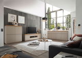 Modernes Wohnzimmer mit XL-TV-Lowboard, Sideboard und Highboard in heller Holzoptik, seitliche Perspektive.