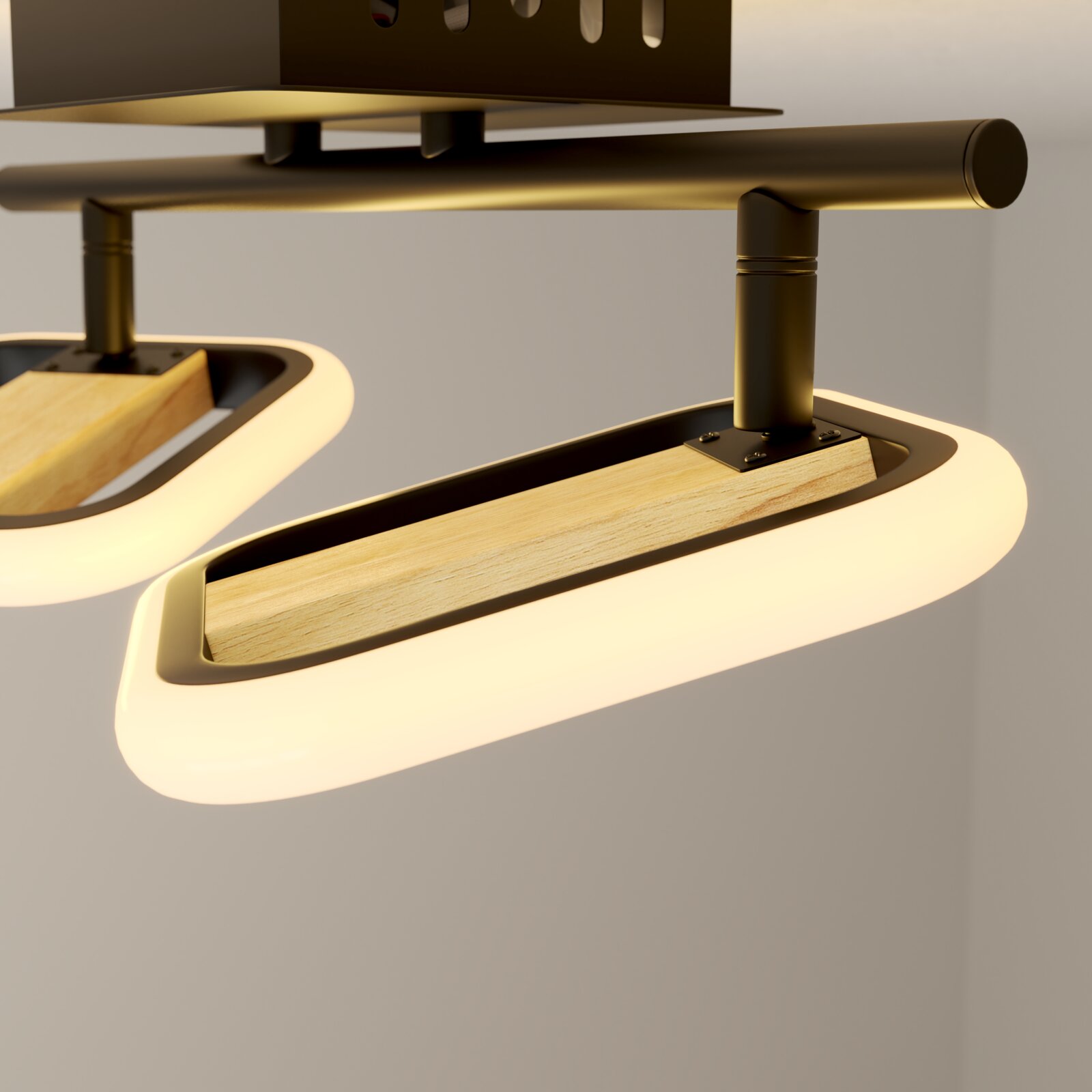 Nahaufnahme einer modernen LED-Deckenleuchte mit ovalen Lichtmodulen, Holz-Inlay und schwarzer Metallhalterung, aus leicht schräger Untersicht