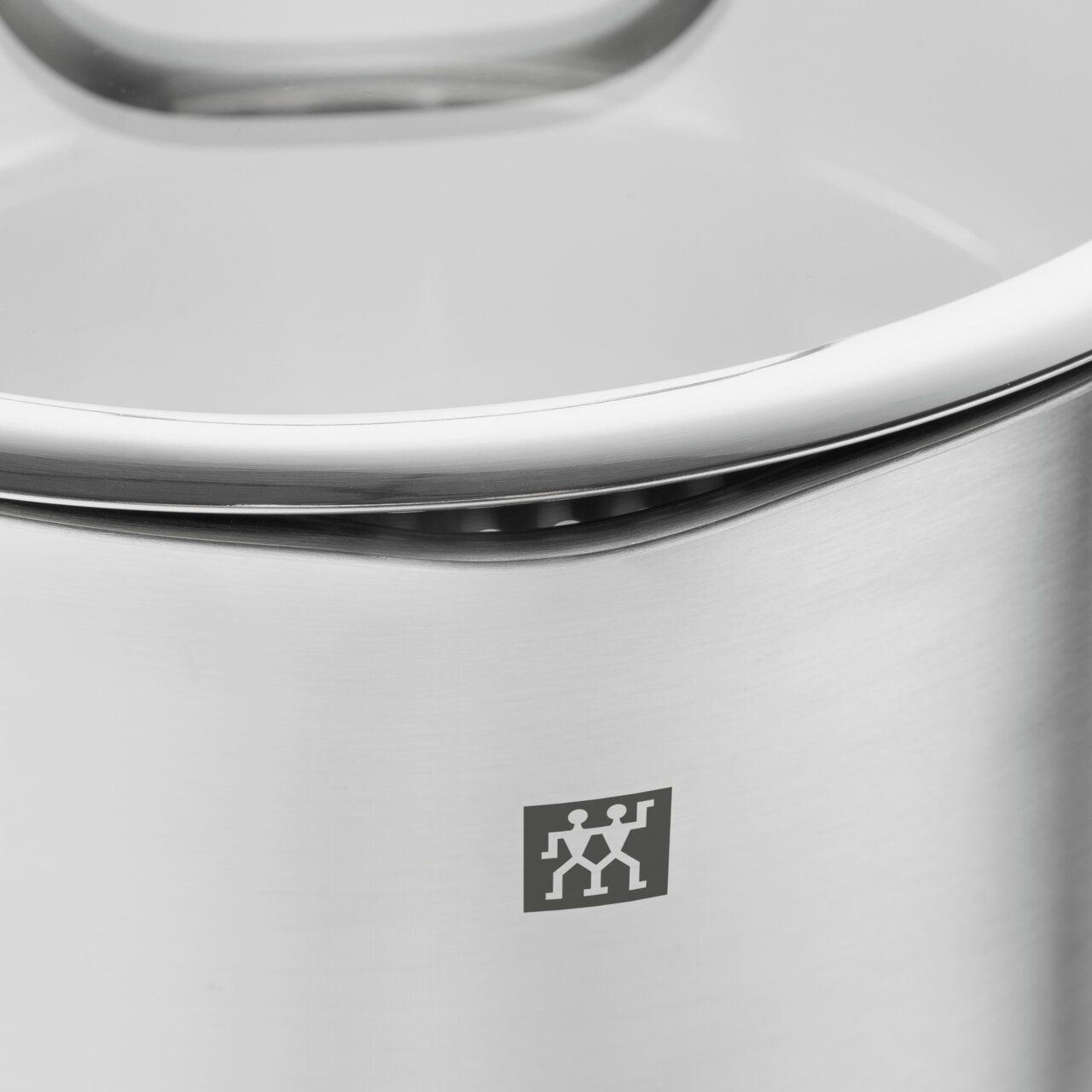 Nahaufnahme eines Edelstahltopfs mit Deckel, Teil eines 5-teiligen Topfsets True Flow, mit sichtbarem Markenlogo.