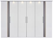 Sechs-türiger Drehtürenschrank in Weiß mit modernen Griffen und integrierter Beleuchtung, Frontalansicht.