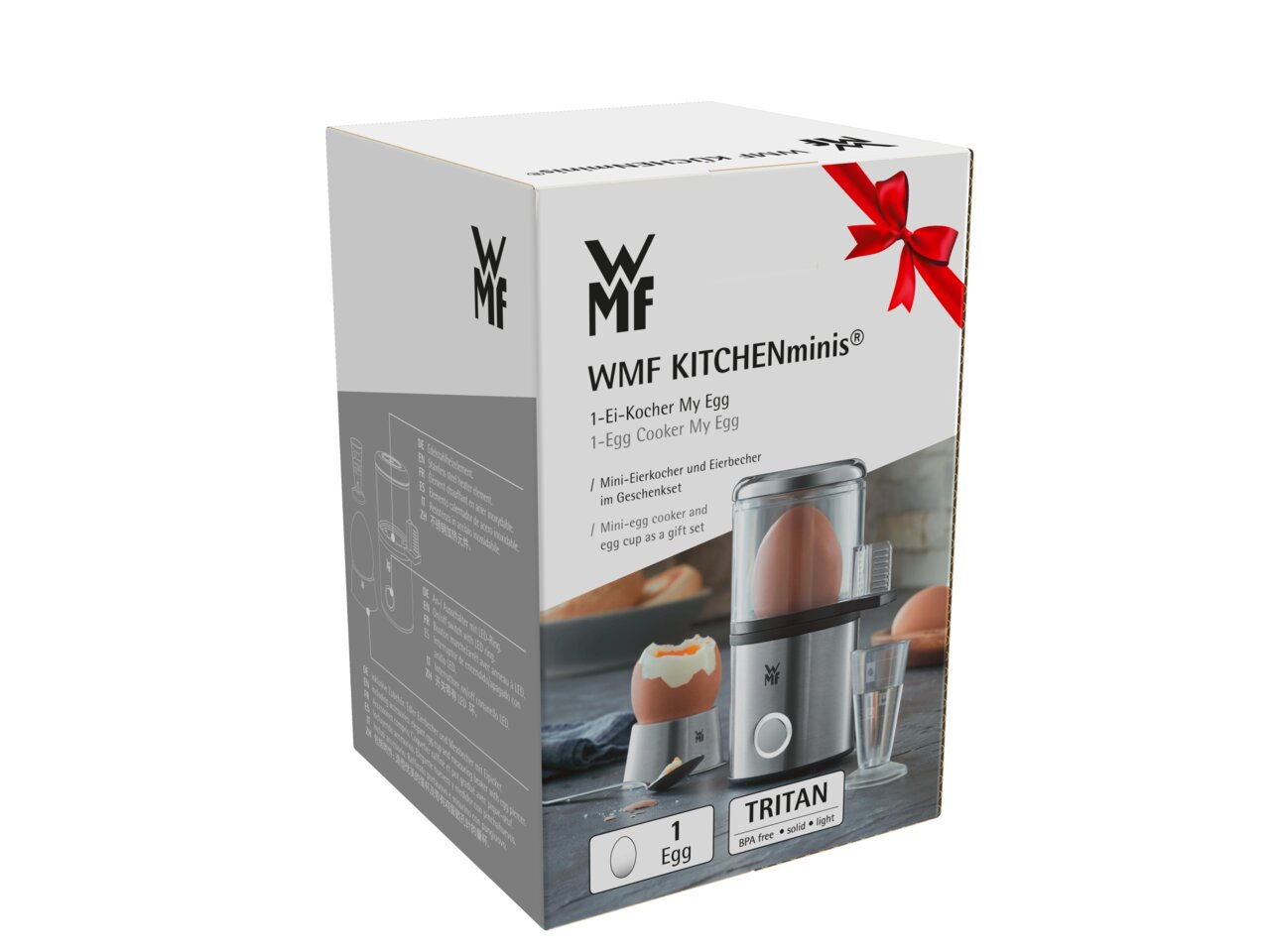 Verpakking van de WMF KITCHENminis-eierkoker MyEgg, vooraanzicht met afbeelding van het product en een rode strik.