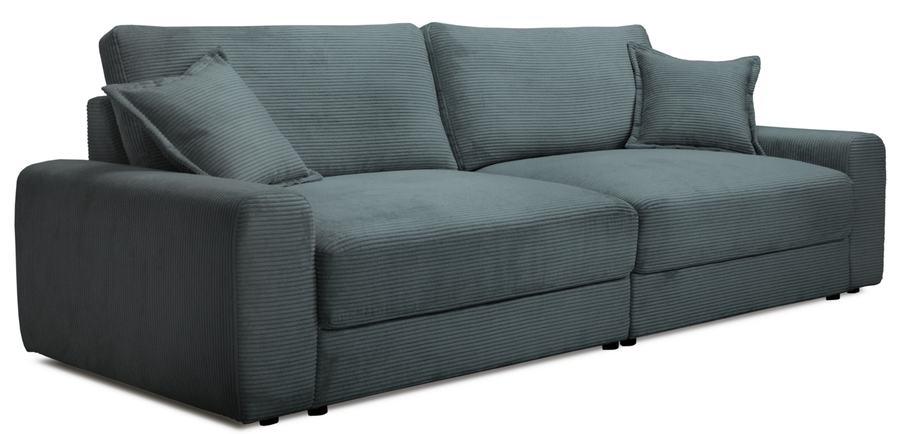 Großes, modernes Big-Sofa in grauer Cordoptik mit zwei passenden Kissen, seitliche Perspektive