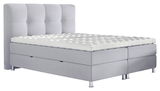 Graues Boxbett mit gestepptem Kopfteil und Matratze, seitliche Perspektive