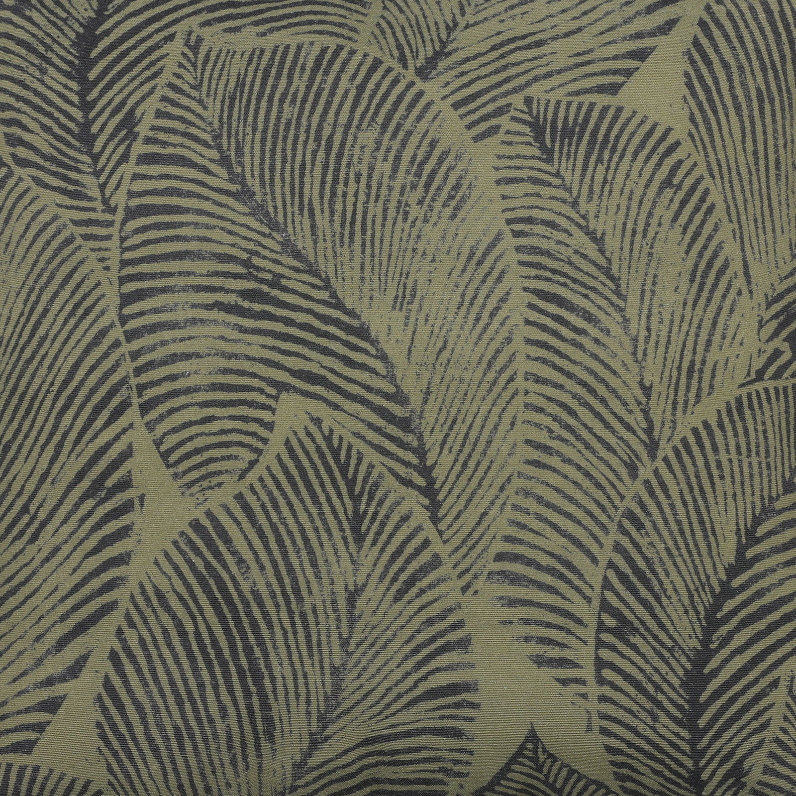 Nahaufnahme eines Stoffmusters mit grünen und schwarzen Blättern, perspektivisch von oben betrachtet.