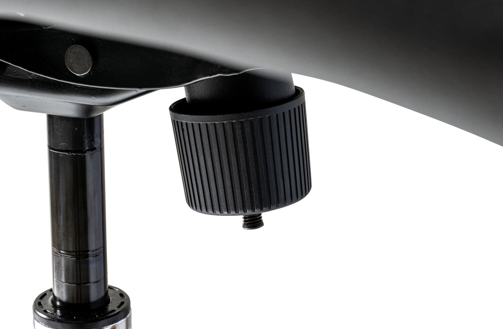 Nahaufnahme eines schwarzen Drehknopfes unter einem Chefsessel, seitliche Perspektive