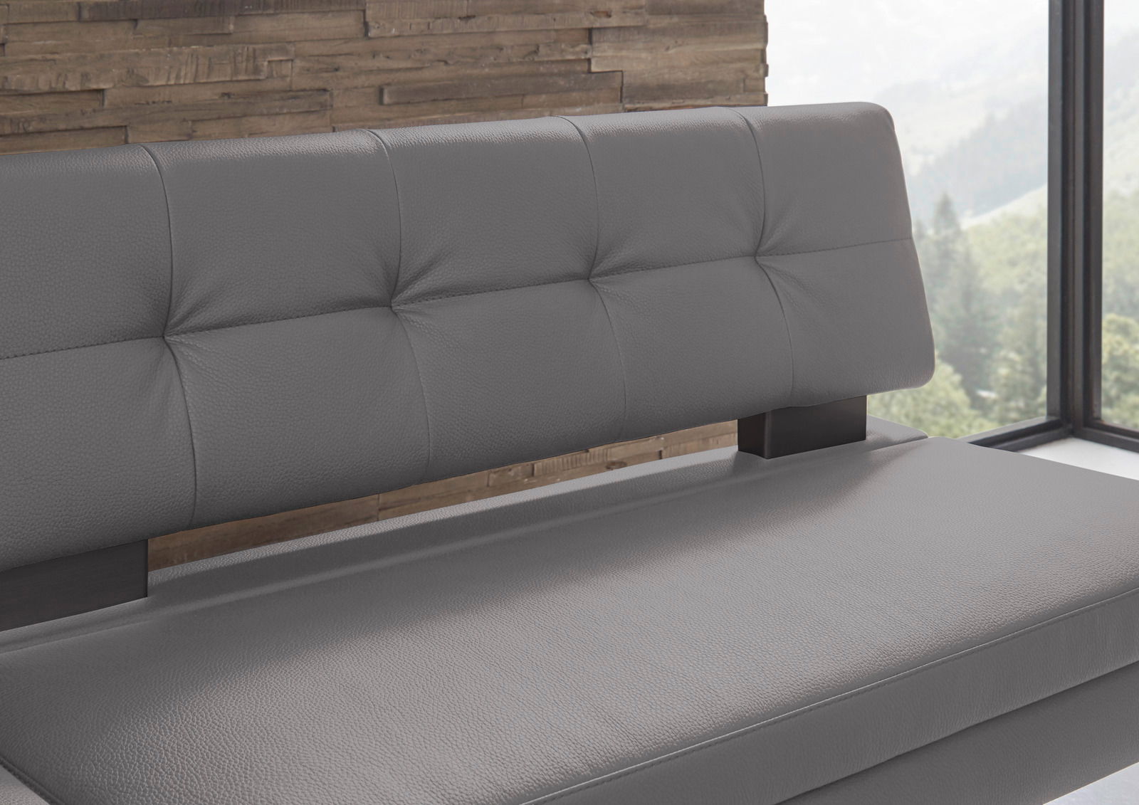Graue Eckbank mit gepolsterter Rückenlehne und Sitzfläche, seitliche Perspektive.