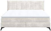 Boxspringbett in Frontalansicht mit gepolstertem Kopfteil und hellem Stoffbezug