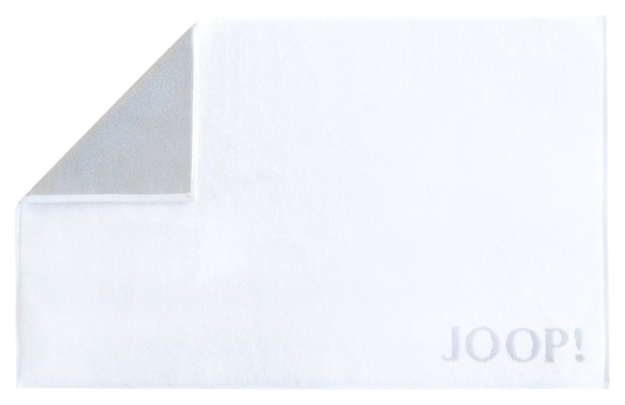 Weiße Badematte mit grauer Rückseite und dem Schriftzug 'JOOP!' in der unteren rechten Ecke, von oben fotografiert.