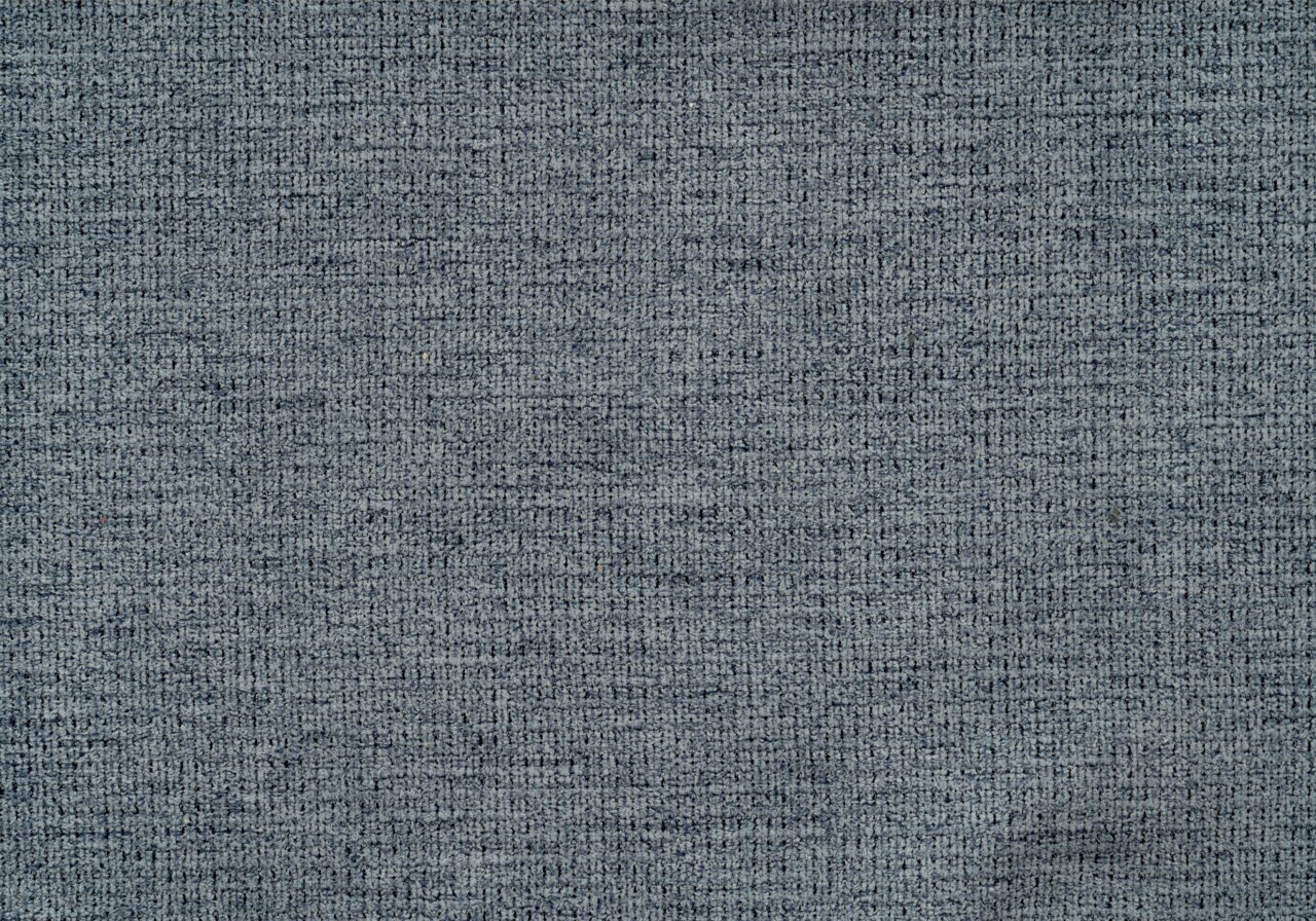 Nahaufnahme eines grauen Stoffmusters mit texturierter Oberfläche, Draufsicht