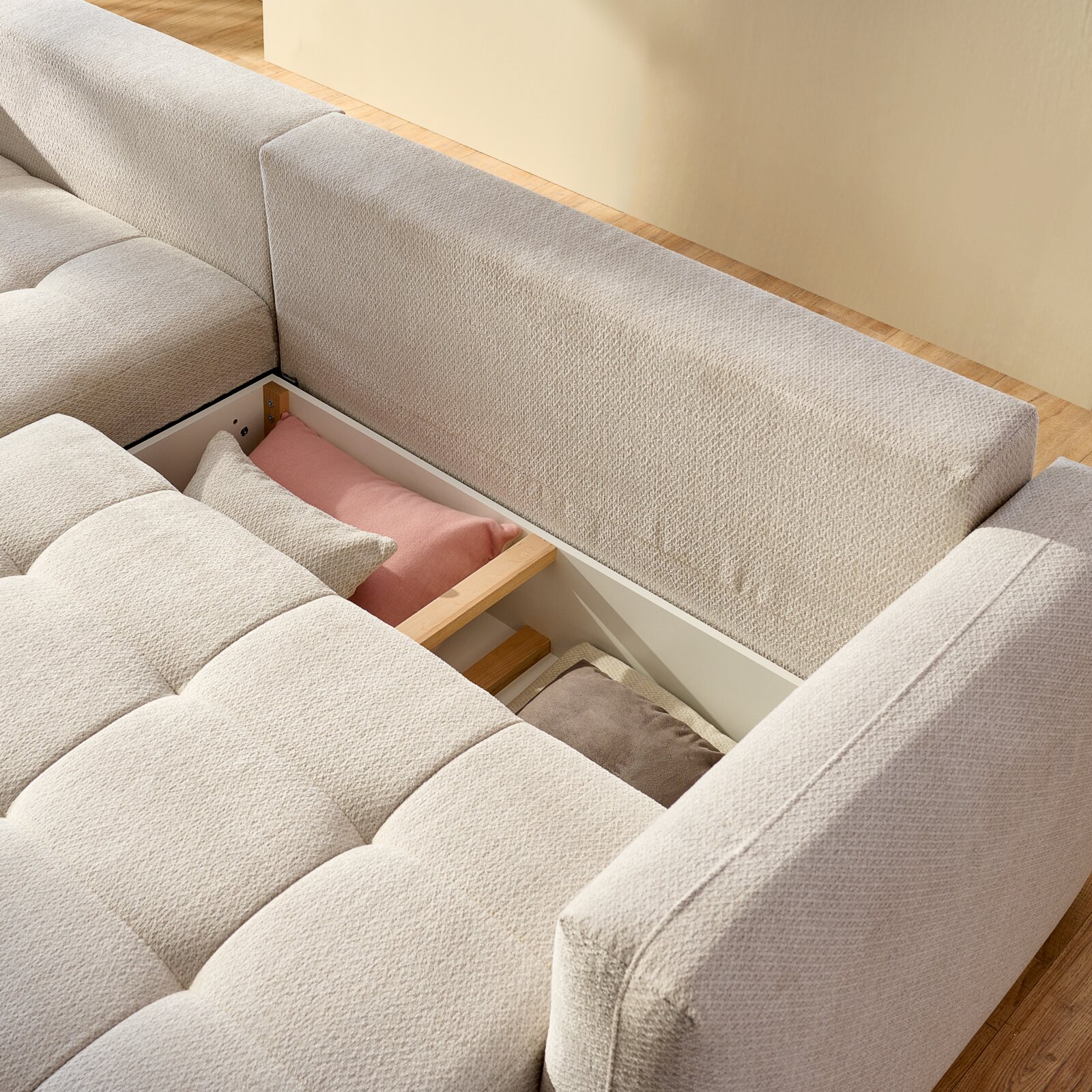Ecksofa London von oben, mit geöffneter Stauraumfunktion und sichtbaren Kissen in verschiedenen Farben.