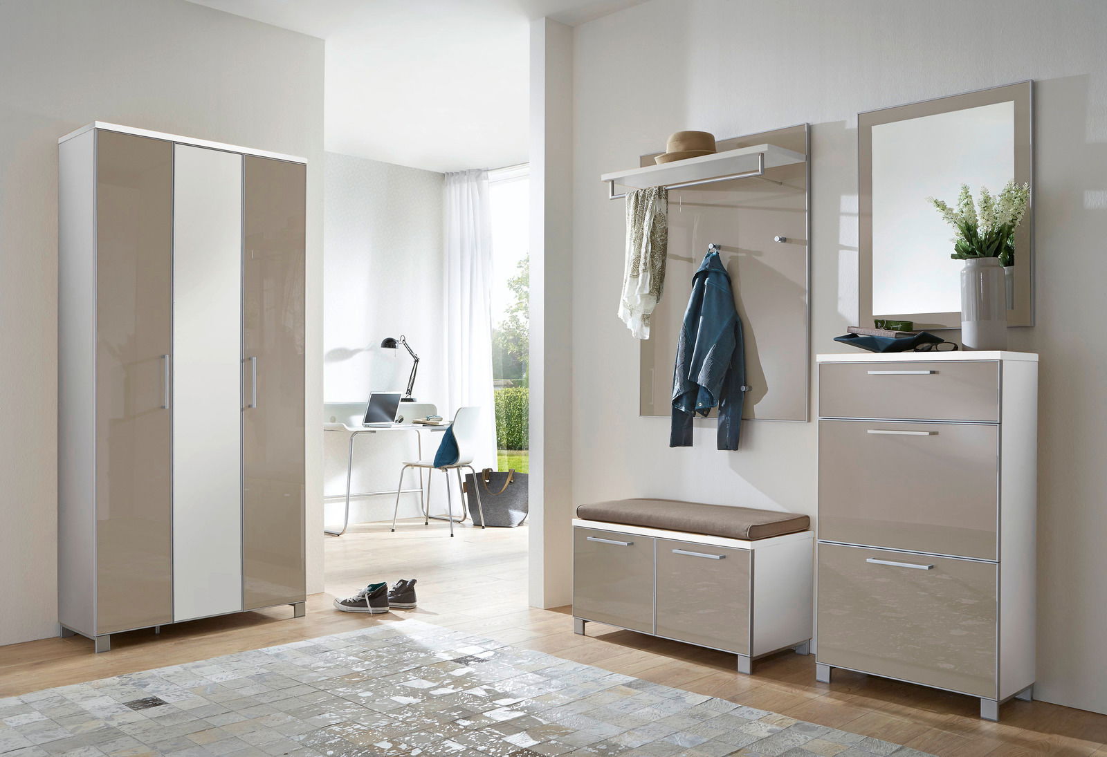 Modernes Garderoben-Set in einem hellen Raum, bestehend aus einem hohen Schrank, einer Sitzbank mit Stauraum, einer Wandgarderobe mit Haken und Ablage sowie einem Spiegel. Perspektive von vorne.