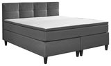 Graues Boxspringbett mit gepolstertem Kopfteil, seitliche Perspektive