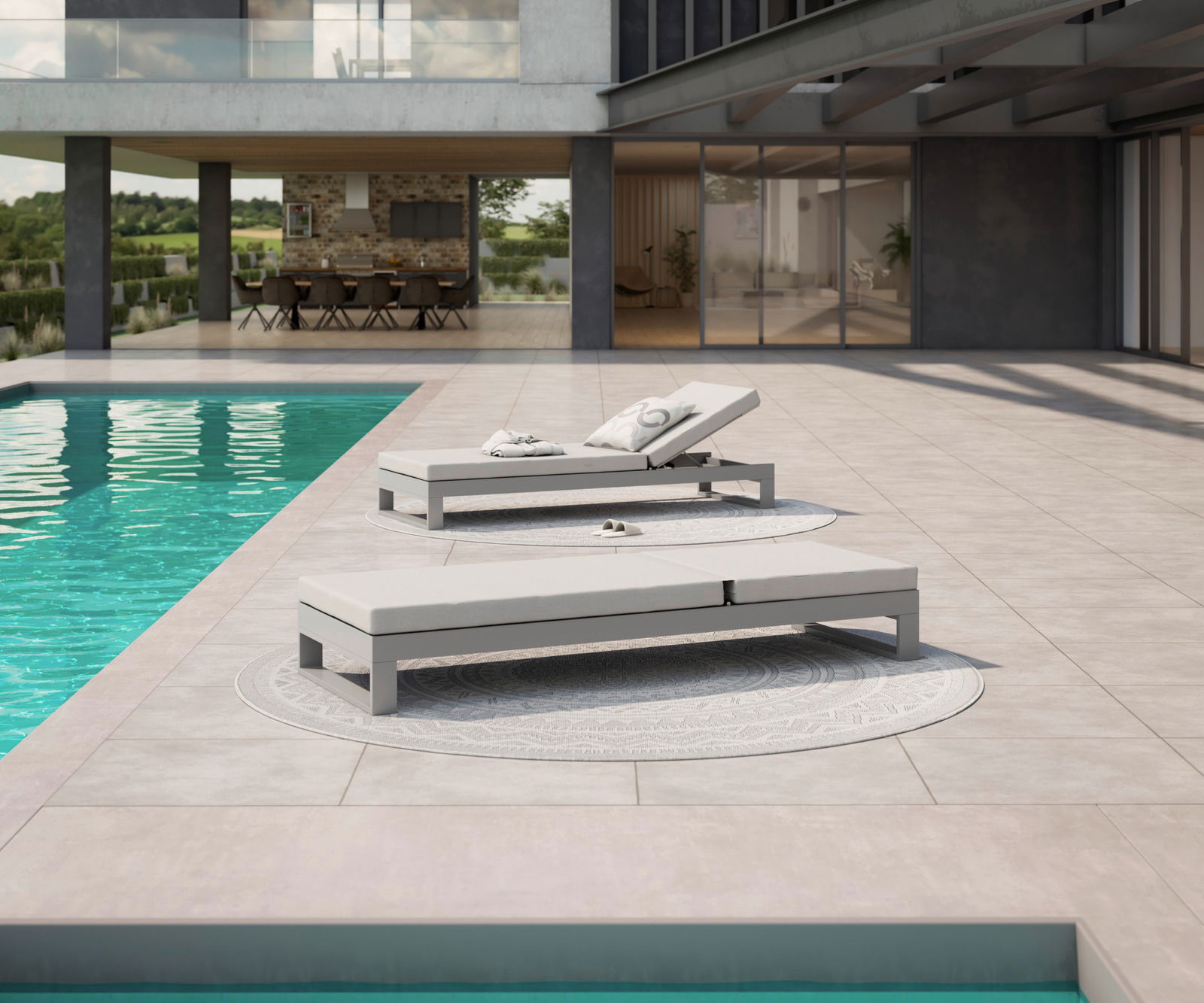 Amatio Sonnenliege WILLIS Zwei moderne Sonnenliegen am Pool auf einer Terrasse mit Blick auf ein stilvolles Gebäude im Hintergrund.