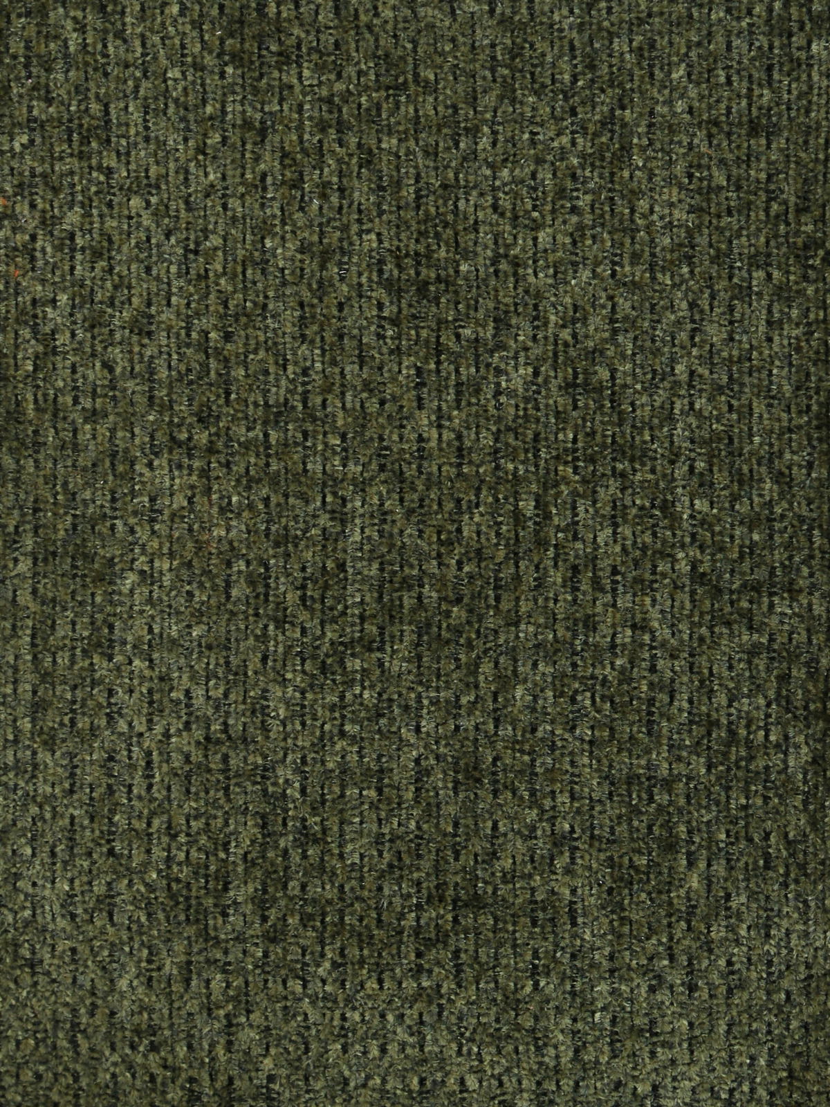 Nahaufnahme eines grünen Stoffmusters, das für einen Armlehnstuhl verwendet wird