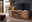 Landscape TV-Lowboard MERAN TV-Element aus Holz mit modernem Design, zwei gelben Vasen und einem Fernseher darauf, seitliche Perspektive.