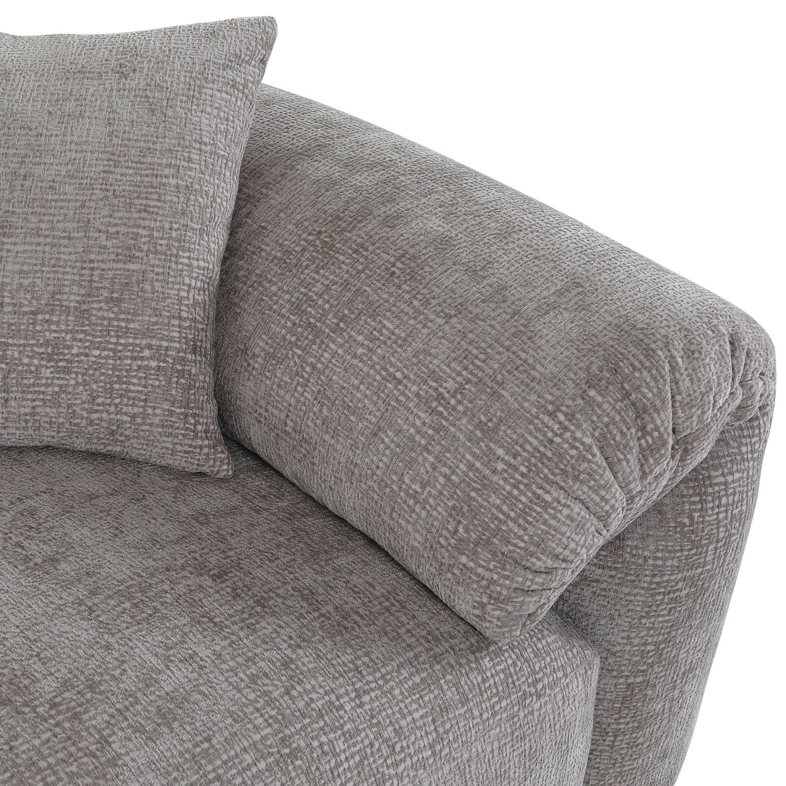 Nahaufnahme einer grauen Sofaecke mit Kissen, Perspektive von oben.