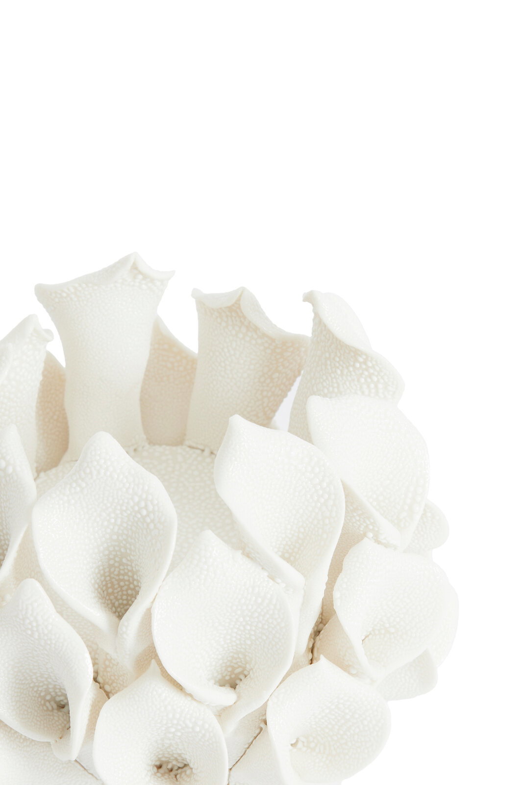 Nahaufnahme eines weißen Teelichthalters mit blütenähnlichen Strukturen, von oben betrachtet.