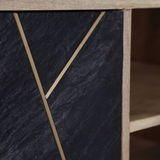 Nahaufnahme eines TV-Lowboards mit schwarzer Steinoptik und goldenen Zierleisten, seitliche Perspektive.