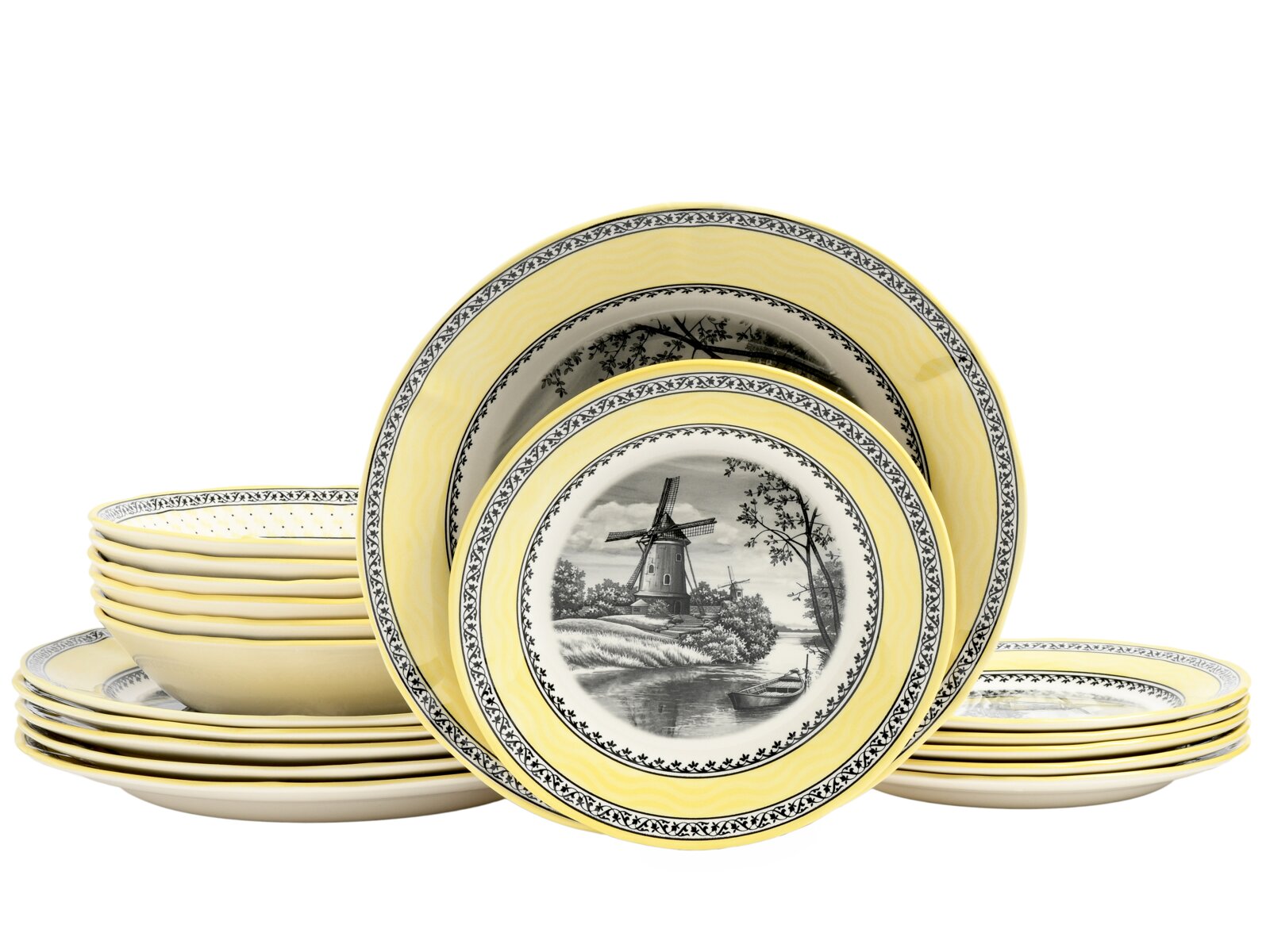 creaTable Tellerset 18-tlg WINDMÜHLE Gelb-weißes Geschirrset mit schwarzen Bordüren und Windmühlen-Landschaftsmotiv, mehrere Teller und Schalen in Frontansicht leicht von oben vor weißem Hintergrund.