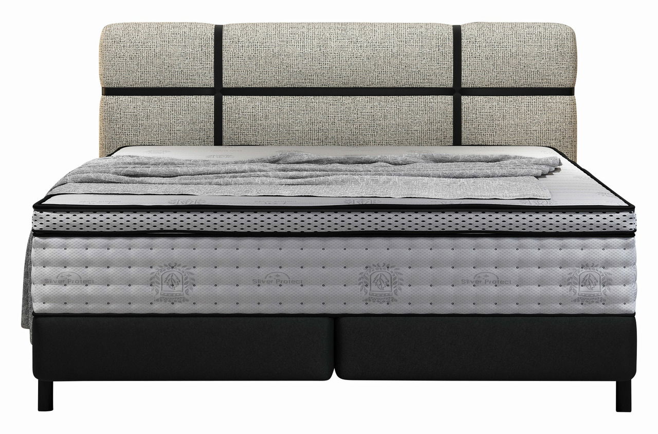Frontale Ansicht eines Boxspringbetts mit gepolstertem Kopfteil und grauer Matratze.