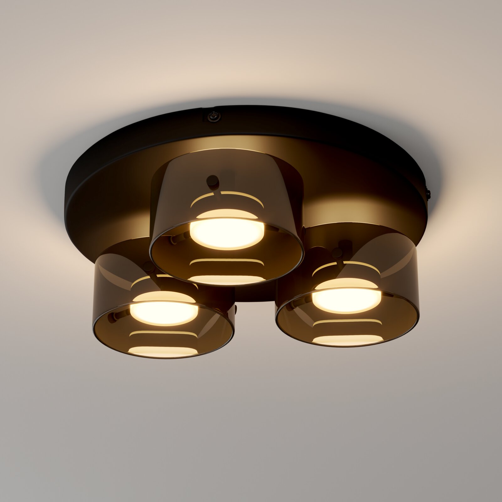 Novel LED-Deckenleuchte Moderne Deckenleuchte mit drei zylindrischen Spots in dunklem Metall/rauchfarbenem Glas, warmweiß leuchtend, aus Untersicht (Blick nach oben)