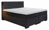 Boxspringbett in dunklem Stoffbezug, seitliche Perspektive