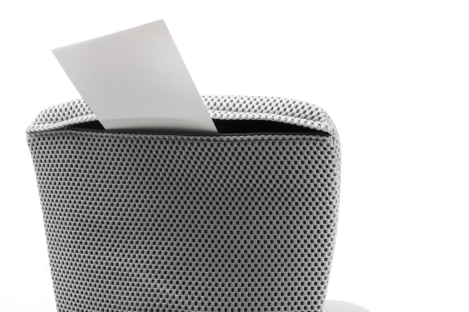 Sitness Kinder-und Jugenddrehstuhl HOME SCOOL Rückansicht eines Kinder- und Jugenddrehstuhls mit grauem Netzbezug und einem weißen Blatt Papier, das aus der Rückenlehne herausragt.