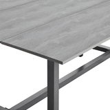 Nahaufnahme eines grauen Tischs mit Metallgestell, perspektivisch von der Seite aufgenommen.