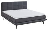 Boxspringbett mit grauem Kopfteil und weißer Matratze, seitliche Perspektive
