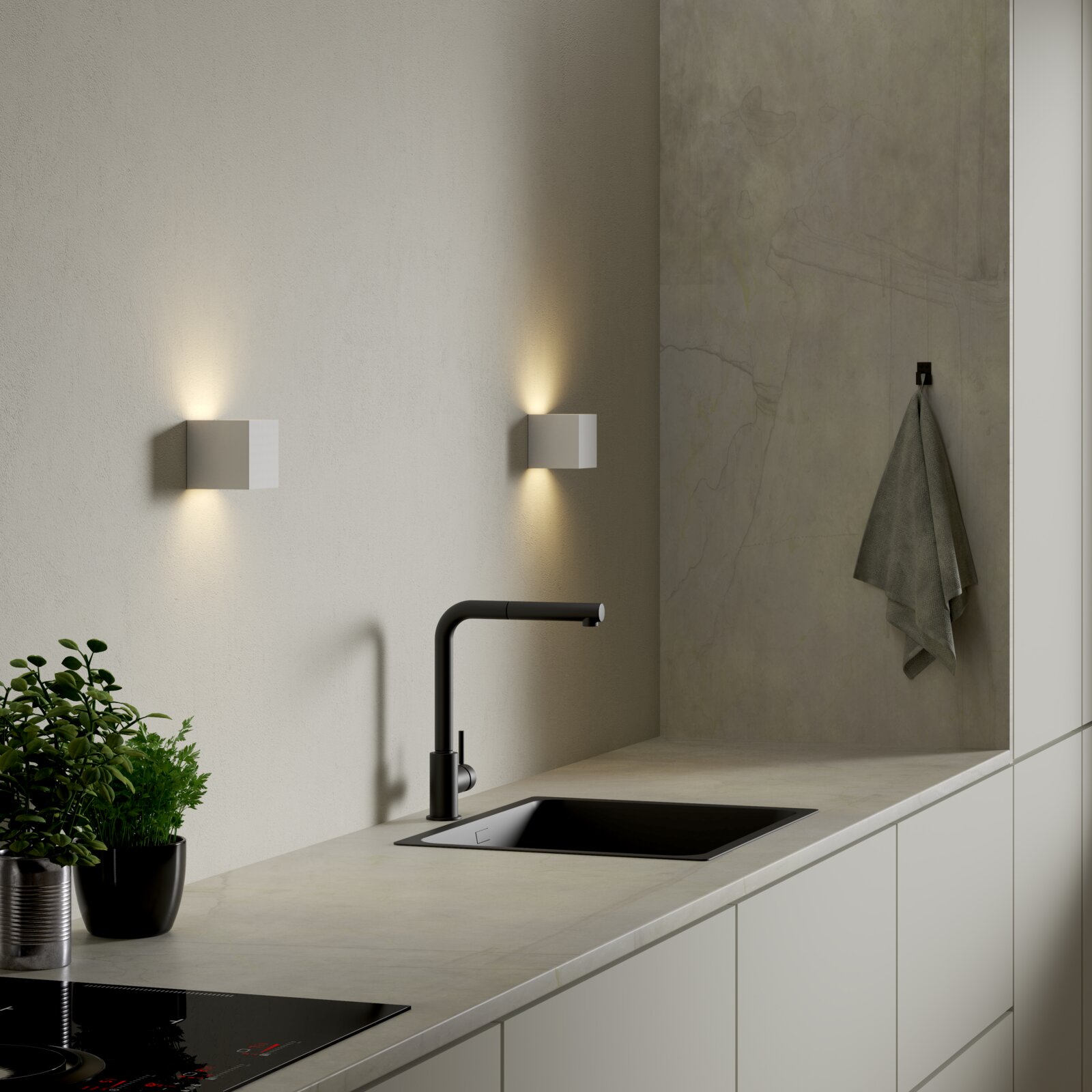 Moderne weiße, würfelförmige Wandleuchte mit Up- und Downlight über einer Küchenarbeitsplatte mit schwarzer Armatur und Spüle, schräger Perspektive von vorne rechts
