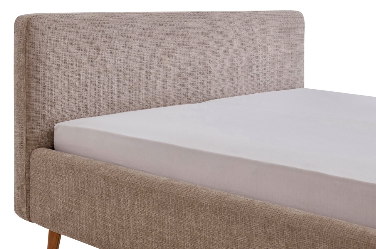 Seitliche Ansicht eines Polsterbettgestells mit beigem Stoffbezug und Holzfüßen.