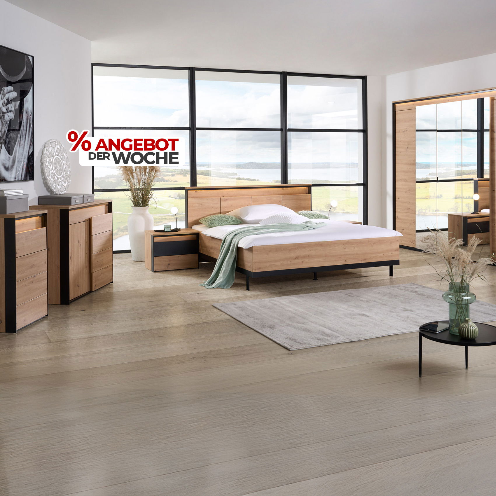 Modernes Schlafzimmer mit Möbeln in Holz-Schwarz-Optik, großem Bett und Panoramafront, gekennzeichnet als „Angebot der Woche“