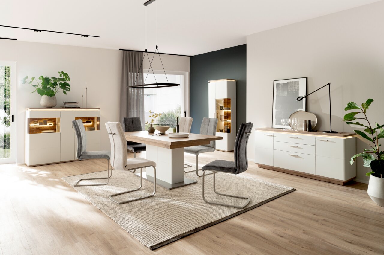 Moderne eethoek met eettafel en stoelen in een lichte ruimte, zijaanzicht.
