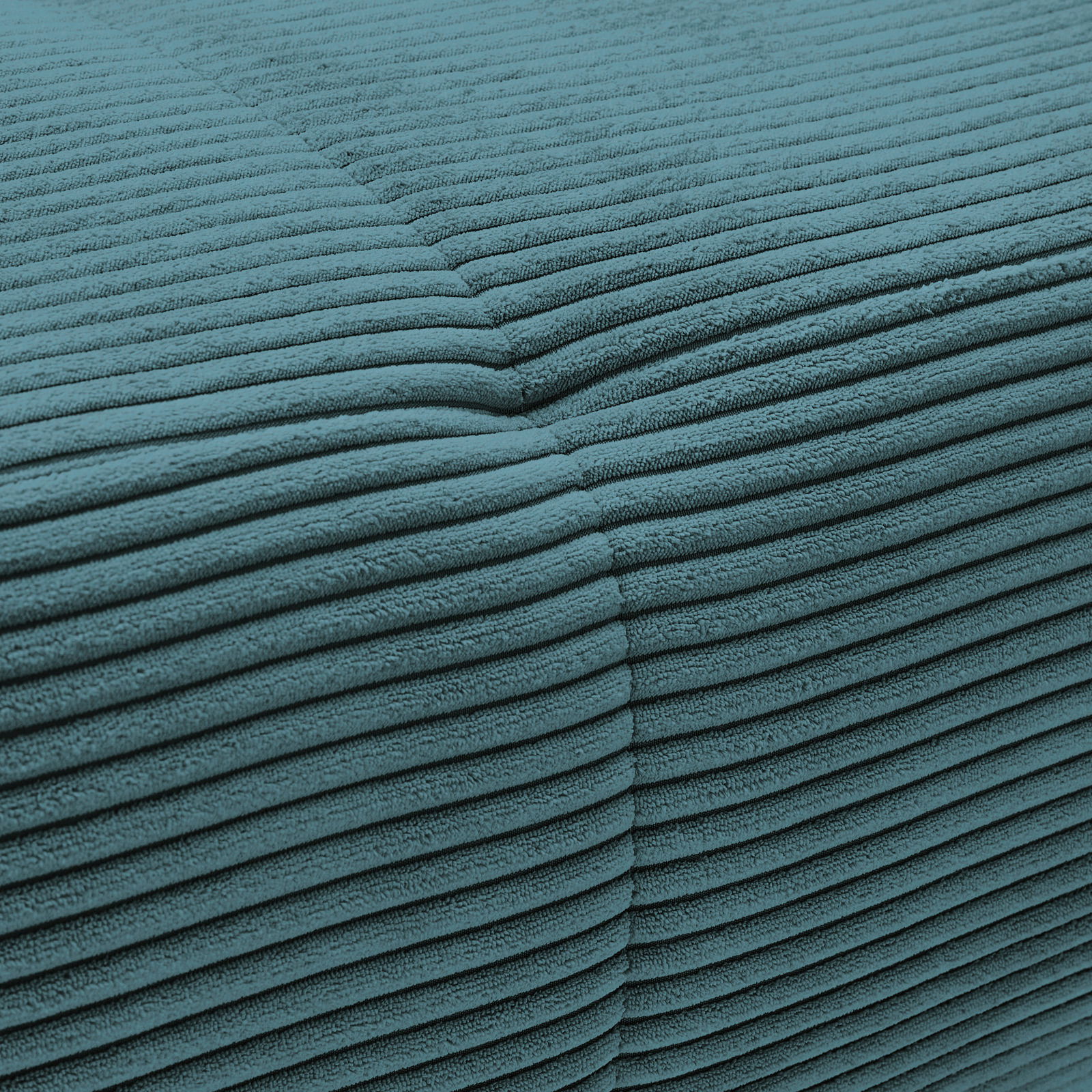 Nahaufnahme eines türkisfarbenen, gerippten Stoffes, der Teil einer Rundecke ist.