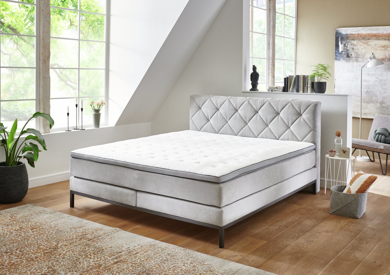 Boxspringbed in een moderne slaapkamer, zijaanzicht