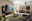 Venjakob Couchtisch 4902 Moderne Wohnzimmermöbel mit LED-Beleuchtung, bestehend aus Hängeschränken, einem TV-Board und einem Couchtisch, aus der Perspektive eines gemütlichen Wohnzimmers mit Blick auf eine große Fensterfront.