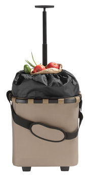 Frontansicht eines beigen Einkaufstrolleys mit schwarzem Griff und gefülltem Innenraum, sichtbar sind Äpfel und eine Gurke.