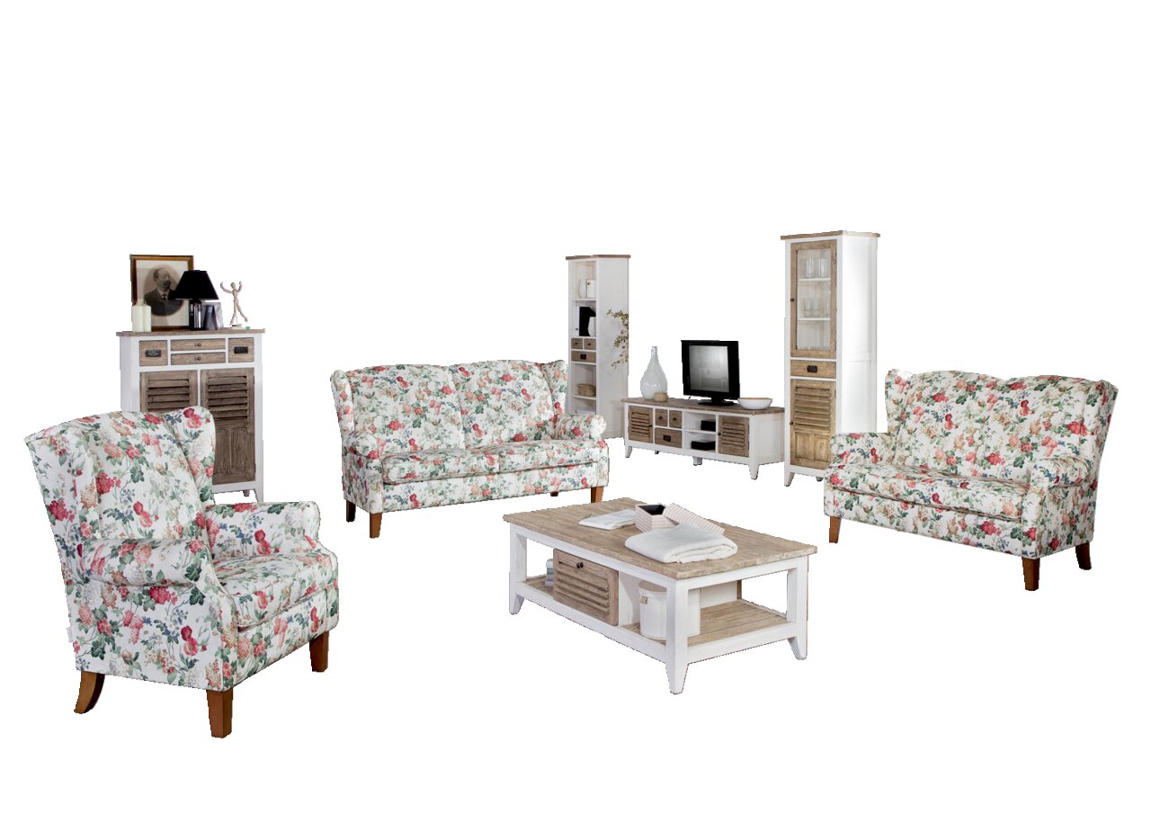 Wohnzimmer mit floraler Sofagarnitur, bestehend aus einem 2,5-sitzigen Sofa und einem Sessel, in einer hellen, modernen Umgebung. Perspektive: Frontalansicht auf die Sofagarnitur.