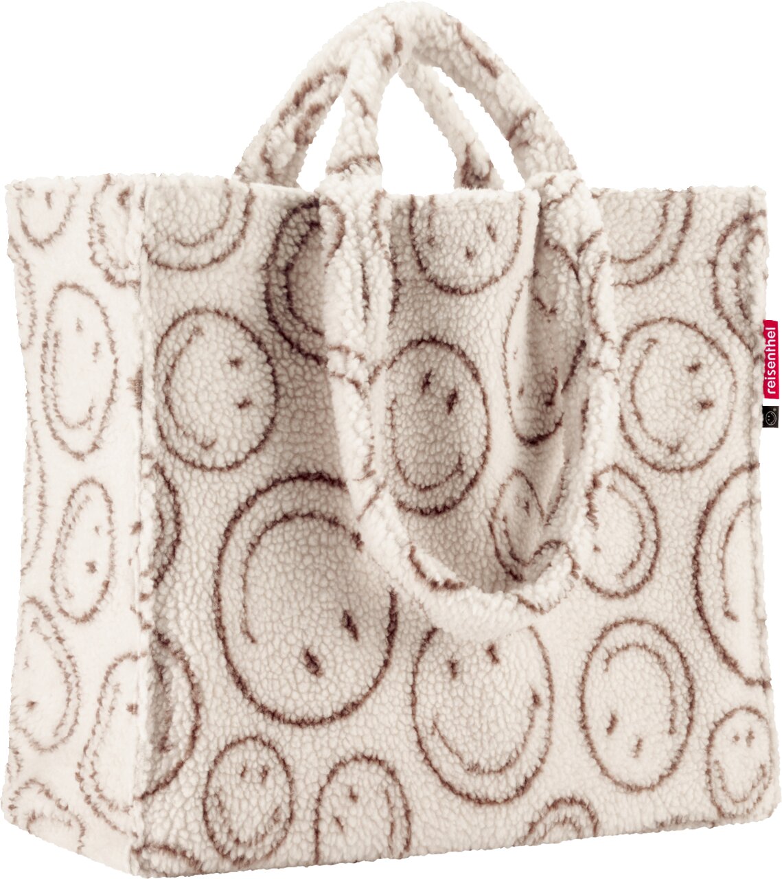 Flauschige Reisenthel Shopper-Tasche aus Teddyfleece in Cremeweiß mit braunem Smileymuster und zwei Henkeln, Frontansicht leicht von oben auf weißem Hintergrund