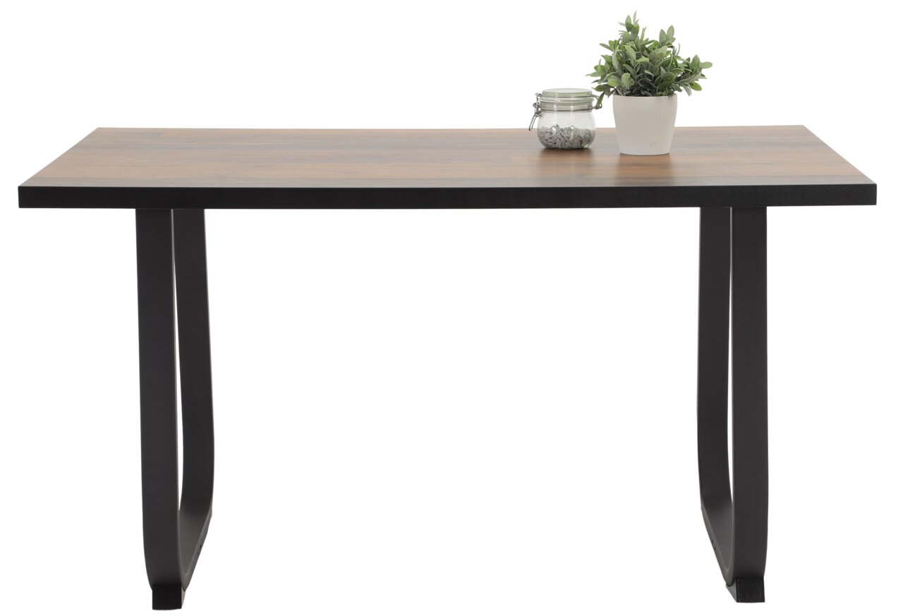 Moderner Esstisch mit Holzplatte und schwarzen Metallbeinen, seitliche Perspektive, dekoriert mit Pflanze und Glasgefäß.