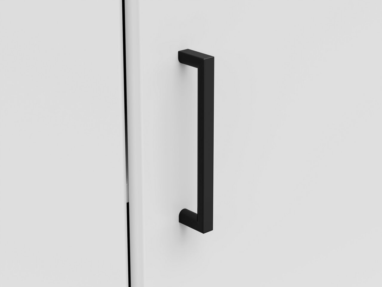 Carryhome Eckkommode MULTISTAURAUM Nahaufnahme einer schwarzen Griffstange an einer weißen Eckkommode, seitliche Perspektive.