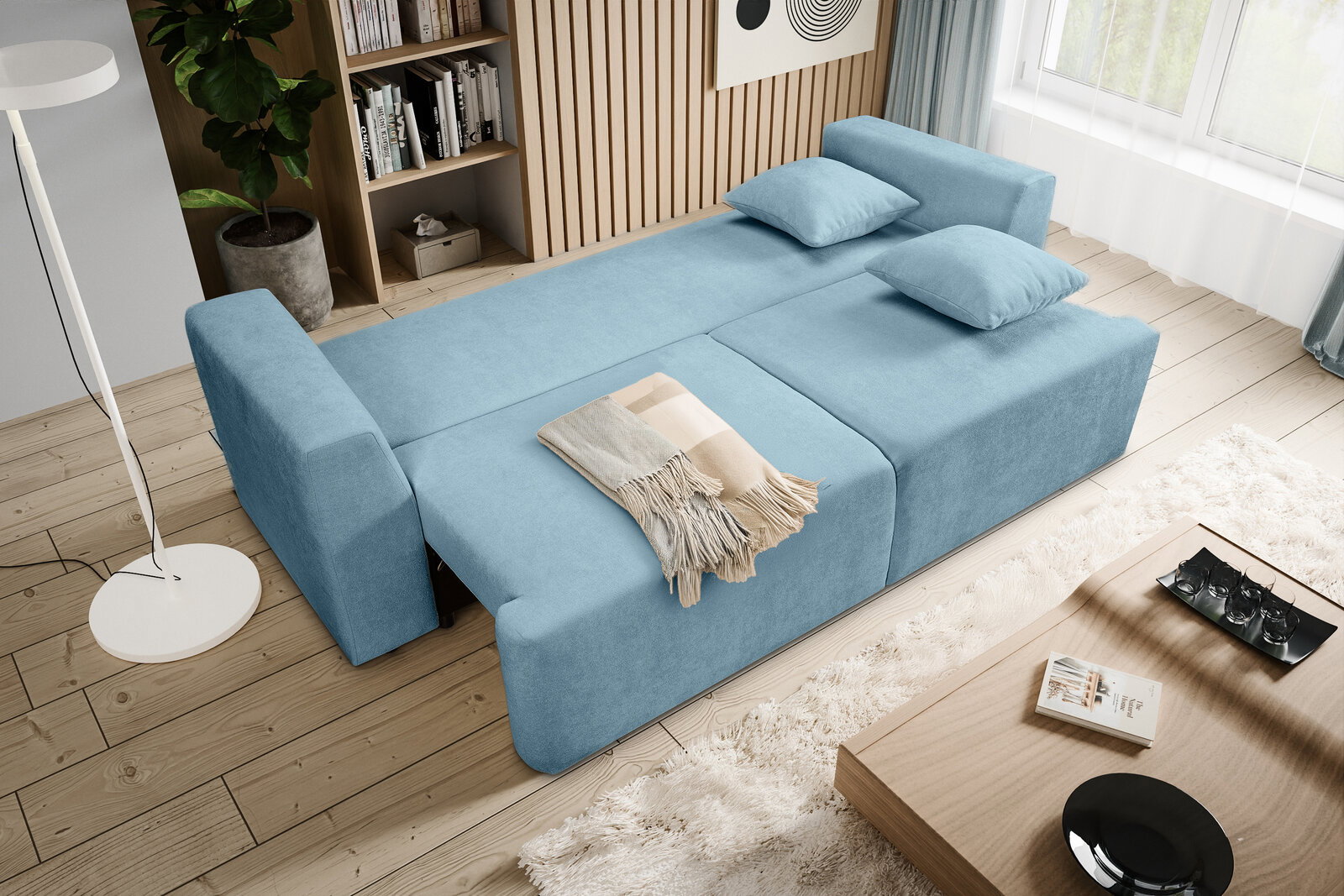 Ausziehbares hellblaues Schlafsofa mit zwei Kissen und Decke im modernen Wohnzimmer, schräg von oben aus der Vogelperspektive fotografiert