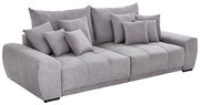 Graues Big-Sofa TAVANI mit mehreren Kissen, seitliche Perspektive