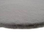 Grauer Fellteppich in Nahaufnahme, flauschige Textur, seitliche Perspektive