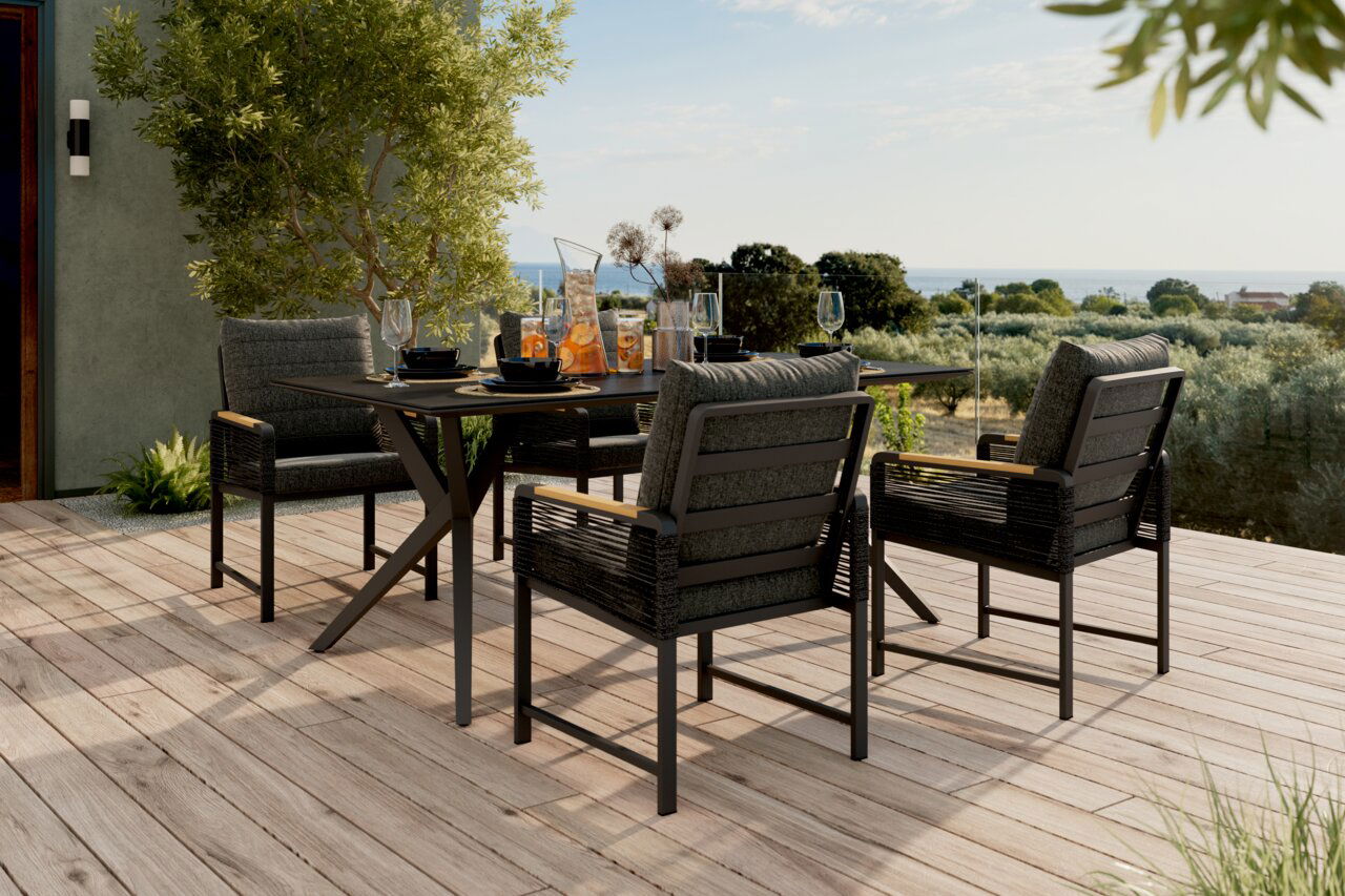 Moderner Gartenstuhl auf einer Terrasse mit Blick auf die Landschaft, umgeben von einem stilvollen Esstisch-Set.