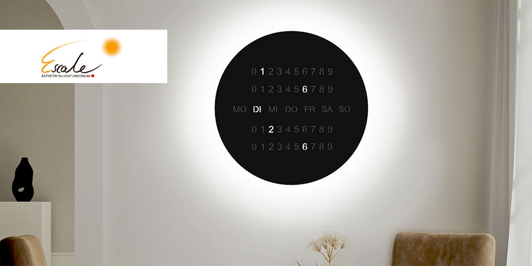 Eine runde, schwarze Wandleuchte zeigt leuchtend den Wochentag und das Datum in einem modernen Raum.