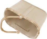 Beige, gerippte Aufbewahrungstasche mit Reißverschluss und klappbarem Metallrahmen, schräg von oben in Seitenansicht fotografiert.